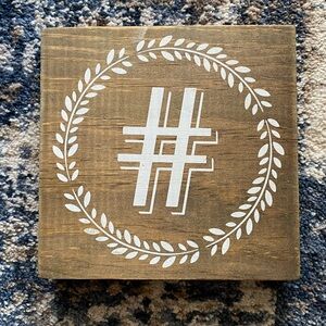 Wood decor with white hashtag and leaf circle